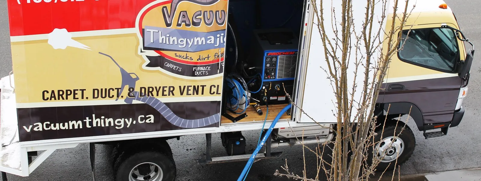Truck parked at a home with hoses running inside
